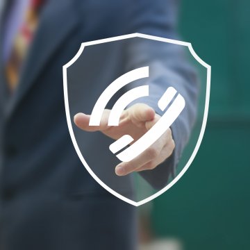 man in suit calling on the phone voip services safe